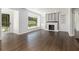 Bright living room featuring a fireplace, built-in shelving, hardwood flooring and view to the exterior at 3423 Rugby Cir, Atlanta, GA 30337