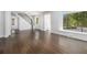 Spacious living room with hardwood flooring, staircase and large window overlooking front yard at 3423 Rugby Cir, Atlanta, GA 30337