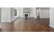 Spacious living room with a fireplace, built-in shelving, and beautiful hardwood flooring at 3423 Rugby Cir, Atlanta, GA 30337
