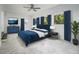Modern bedroom with blue accents, tile flooring, and natural light from multiple windows at 3423 Rugby Cir, Atlanta, GA 30337
