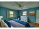 Bedroom with a large bed, two windows, and blue accent wall paint at 2520 Overlook Ne Way, Atlanta, GA 30345