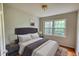 Cozy bedroom with a tufted headboard, neutral colors, and two sunny windows at 2520 Overlook Ne Way, Atlanta, GA 30345