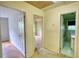 Hallway with doors leading to multiple rooms and a bathroom with green tile at 2520 Overlook Ne Way, Atlanta, GA 30345