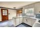 Kitchen with white cabinets, blue countertops and flooring, and a window over sink at 2520 Overlook Ne Way, Atlanta, GA 30345