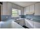 White kitchen features a stainless sink, electric stovetop and plenty of cabinet storage at 2520 Overlook Ne Way, Atlanta, GA 30345