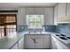 Kitchen featuring white cabinets, blue countertops, and natural light from large window at 2520 Overlook Ne Way, Atlanta, GA 30345