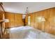 Living room with a staircase, wood paneling, carpeted floors, and vintage lamps at 2520 Overlook Ne Way, Atlanta, GA 30345