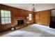 Living room with wood paneling, brick fireplace, and carpeted floors at 2520 Overlook Ne Way, Atlanta, GA 30345