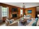 Cozy living room with a brick fireplace, wood paneling, and comfortable furnishings at 2520 Overlook Ne Way, Atlanta, GA 30345