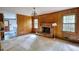 Living room showcasing a brick fireplace, wood-paneled walls, and carpeted flooring at 2520 Overlook Ne Way, Atlanta, GA 30345