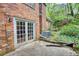 Back patio featuring brick architecture, French doors, and access to the beautiful landscaped yard at 2520 Overlook Ne Way, Atlanta, GA 30345