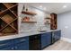 Stylish basement bar area with granite countertop, stone backsplash, and wine racks at 3250 Twisted Branches Ln, Marietta, GA 30068