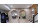 Finished basement with brick archway and multiple recreational areas and stairs at 3250 Twisted Branches Ln, Marietta, GA 30068