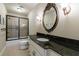 Bathroom features a granite countertop vanity, framed mirror, and glass enclosed shower at 3250 Twisted Branches Ln, Marietta, GA 30068