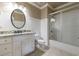Updated bathroom featuring granite countertops, white cabinetry, and a shower and bathtub at 3250 Twisted Branches Ln, Marietta, GA 30068