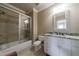 Neutral bathroom features a tub-shower, decorative mirror, and granite countertop vanity at 3250 Twisted Branches Ln, Marietta, GA 30068