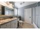 Bathroom with large mirror, granite counters, white cabinetry, and glass enclosed shower at 3250 Twisted Branches Ln, Marietta, GA 30068