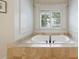 Close-up of a built-in bathtub with a modern faucet, offering a serene bathing experience at 3250 Twisted Branches Ln, Marietta, GA 30068