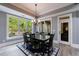 Dining room with large windows overlooking the greenery, a chandelier, and a table at 3250 Twisted Branches Ln, Marietta, GA 30068