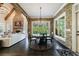 Elegant dining area features a round table, stone accent wall, large windows, and a stylish chandelier at 3250 Twisted Branches Ln, Marietta, GA 30068