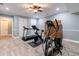 Bright workout room with treadmill, stationary bike, elliptical, and neutral walls at 3250 Twisted Branches Ln, Marietta, GA 30068