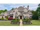 Stunning two-story brick home with meticulously landscaped front yard and charming architectural details at 3250 Twisted Branches Ln, Marietta, GA 30068