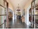 Grand foyer with dark hardwood floors, arched doorways, and a decorative chandelier at 3250 Twisted Branches Ln, Marietta, GA 30068