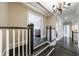 Open hallway with dark hardwood floors and view to the living room and lighting at 3250 Twisted Branches Ln, Marietta, GA 30068