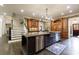 Open kitchen with a large island, stainless steel appliances, and stylish stone backsplash at 3250 Twisted Branches Ln, Marietta, GA 30068