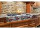 Kitchen featuring a high-end stainless steel cooktop, custom cabinetry, and stone backsplash at 3250 Twisted Branches Ln, Marietta, GA 30068