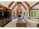 Spacious living room boasts exposed beams, a stone fireplace, and a comfortable seating arrangement at 3250 Twisted Branches Ln, Marietta, GA 30068