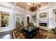 Inviting living room with a fireplace, built-in bookshelves, and French doors leading to the outside at 3250 Twisted Branches Ln, Marietta, GA 30068