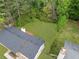 Aerial view of a spacious, fenced backyard with lush green lawn and mature trees at 3451 Birchwood Trl, Snellville, GA 30078