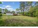 Expansive backyard with mature trees, featuring a house with a wood deck at 3451 Birchwood Trl, Snellville, GA 30078