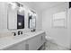 Bright bathroom features a double sink vanity, black fixtures, shiplap walls and decorative mirrors at 3451 Birchwood Trl, Snellville, GA 30078