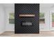 Close-up of the fireplace, featuring black chevron pattern and wooden mantel at 3451 Birchwood Trl, Snellville, GA 30078