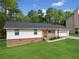 Charming single-story home features a well-manicured lawn, brick accents, and a welcoming front porch at 3451 Birchwood Trl, Snellville, GA 30078