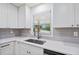 Bright kitchen featuring stainless steel faucet and sink and a view through the window to the outdoors at 3451 Birchwood Trl, Snellville, GA 30078