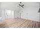 Bright living room with new floors, a ceiling fan, and a white wall at 3451 Birchwood Trl, Snellville, GA 30078
