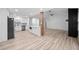 Open concept kitchen and living room with light wood floors and recessed lighting at 3451 Birchwood Trl, Snellville, GA 30078