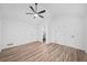 Bright main bedroom with a modern ceiling fan, light wood flooring, and crisp, white walls at 3451 Birchwood Trl, Snellville, GA 30078