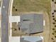 Aerial top-down view of a gray home with landscaping, driveway, and a new roof at 3698 Annsbury Ct, Lilburn, GA 30047