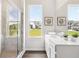 A modern bathroom features a glass shower and bright window with a lawn view at 3698 Annsbury Ct, Lilburn, GA 30047