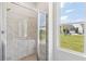 A walk-in shower features marble walls and a glass door; a window offers an exterior view at 3698 Annsbury Ct, Lilburn, GA 30047