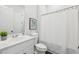 This bathroom features a vanity, toilet, and shower with a white shower curtain at 3698 Annsbury Ct, Lilburn, GA 30047