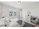 This bedroom has neutral walls, carpet, and a sunny window with a view to the backyard at 3698 Annsbury Ct, Lilburn, GA 30047