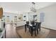 Contemporary dining room with wood floors, stylish lighting, and adjacent view of the living area at 3698 Annsbury Ct, Lilburn, GA 30047