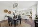 Elegant dining area offering wood floors, modern light fixture and flows into a spacious kitchen and living space at 3698 Annsbury Ct, Lilburn, GA 30047