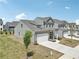 New construction gray home with front-entry two-car garage and landscaping in a suburban neighborhood at 3698 Annsbury Ct, Lilburn, GA 30047