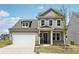 Charming two-story home with a well-manicured lawn, a two-car garage, and covered entryway at 3698 Annsbury Ct, Lilburn, GA 30047